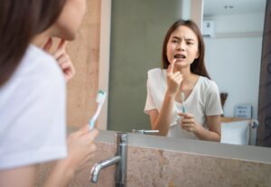 young asian woman brushing teeth with sensitive te 2022 05 06 01 58 23 utc 2 1